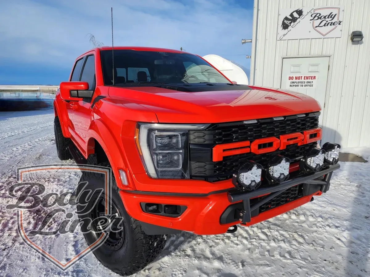 Red Ford F-150 Raptor protected with Body-Liner coating at the Body-Liner shop in Alberta