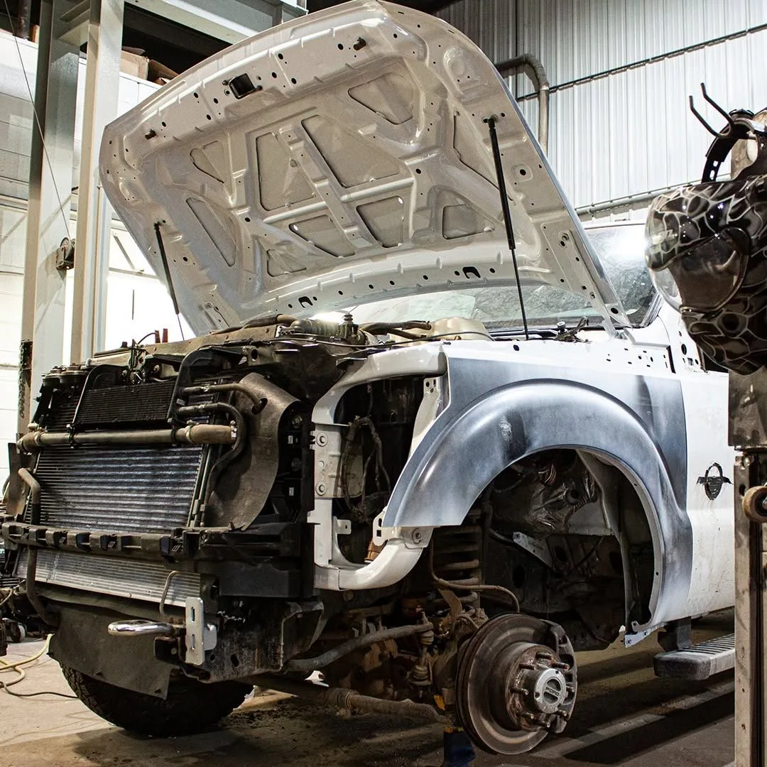 Collision repair in progress on a Ford Super Duty at a Grande Prairie auto body shop
