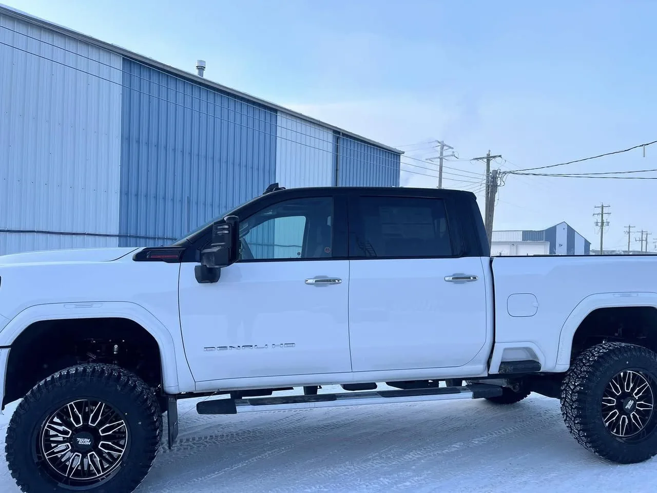 Detailed lifted GMC Denali HD at a Grande Prairie auto body shop