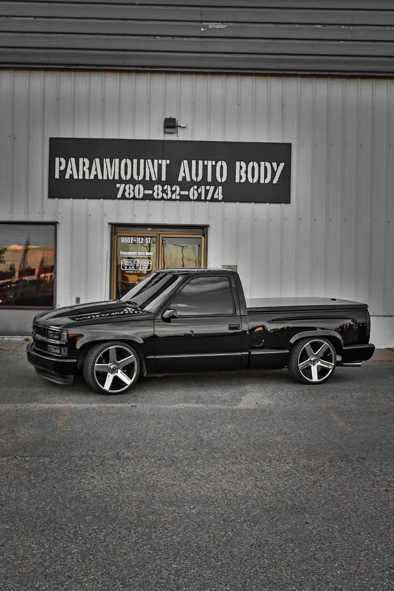 Lowered custom Chevrolet pickup outside the Paramount Auto Body shop