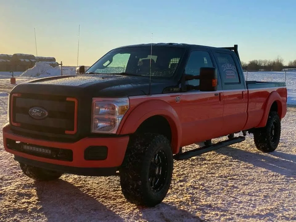 Two-tone orange and black Ford F-350 Super Duty company truck painted at Paramount Auto Body
