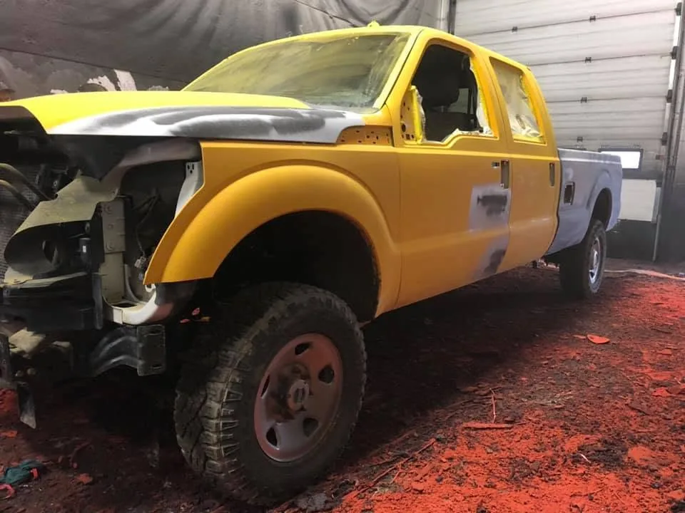 Ford F-350 being resprayed yellow in the Paramount Auto Body spray booth